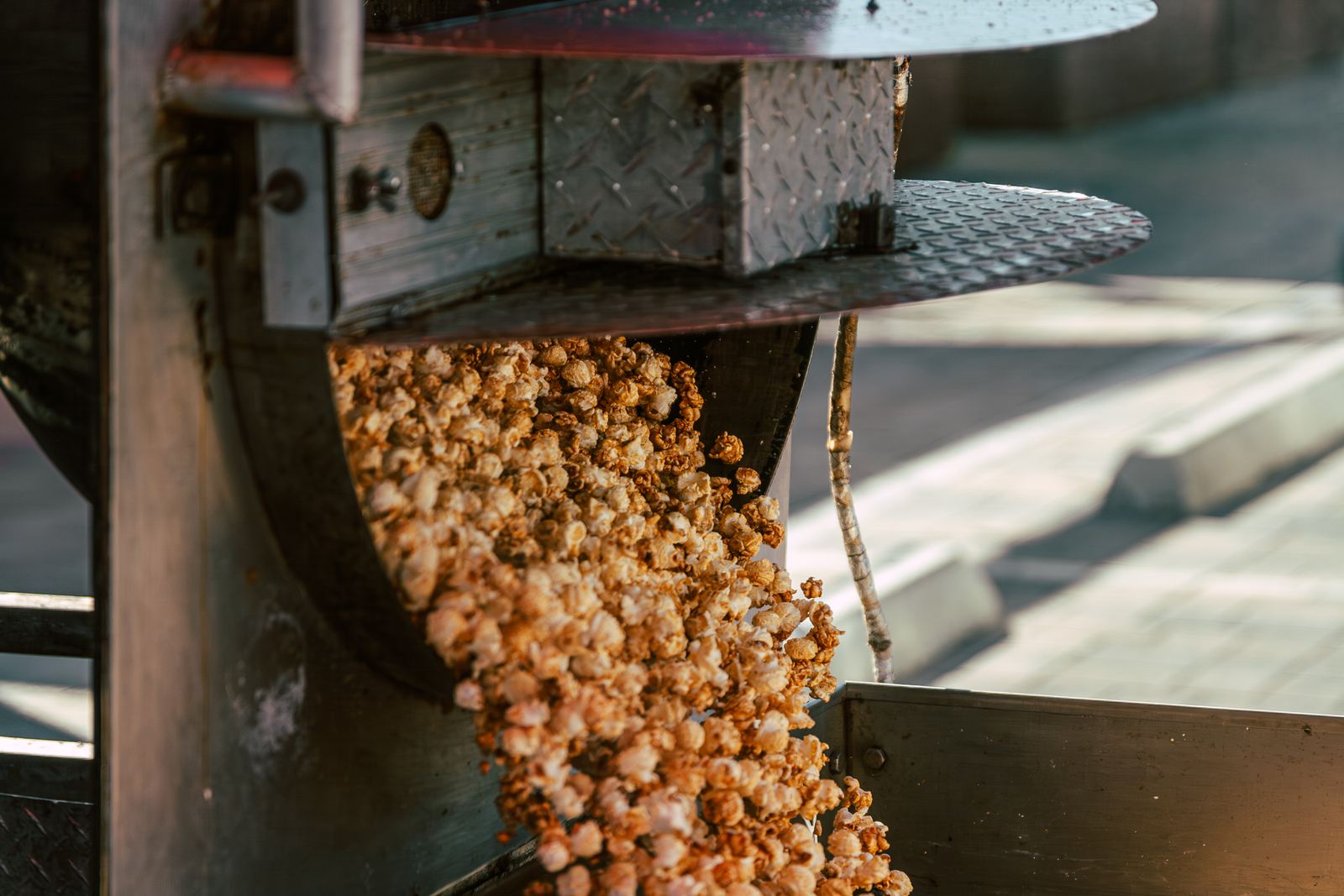 Fresh caramel corn tumbling out of the kettle